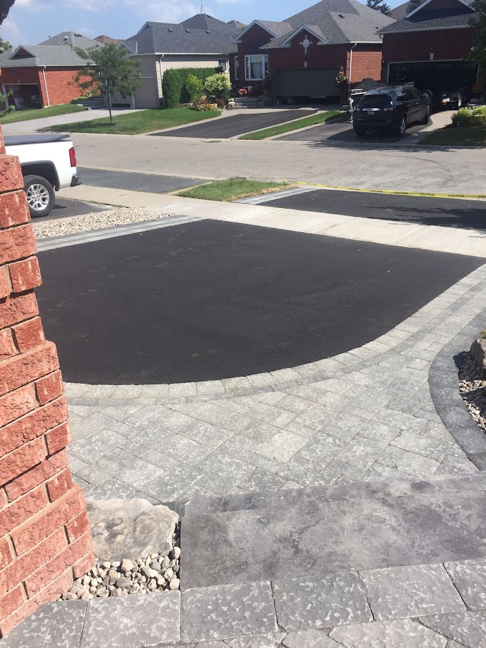 paved driveway with interlocking brick trim