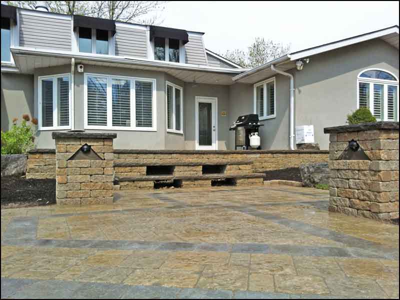 backyard with brown interlocking bricks and steps