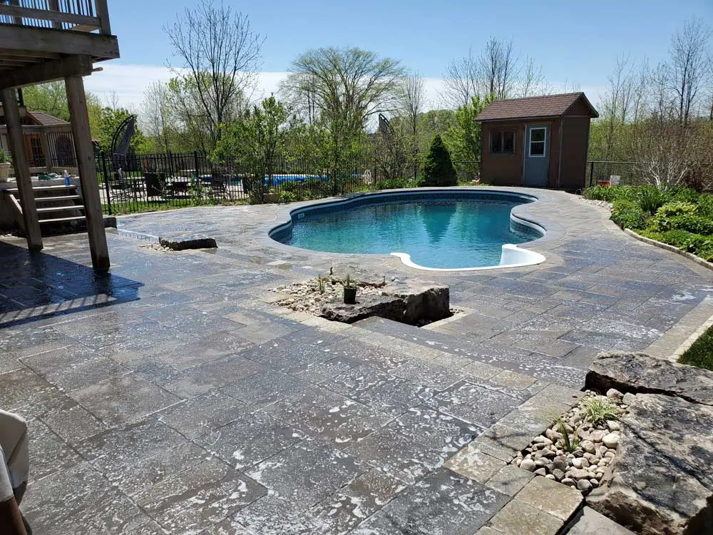 pool with interlocking brick patio